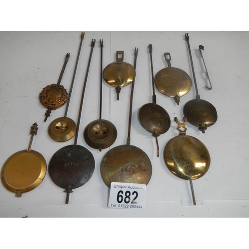 682 - A mixed lot of old clock pendulums.