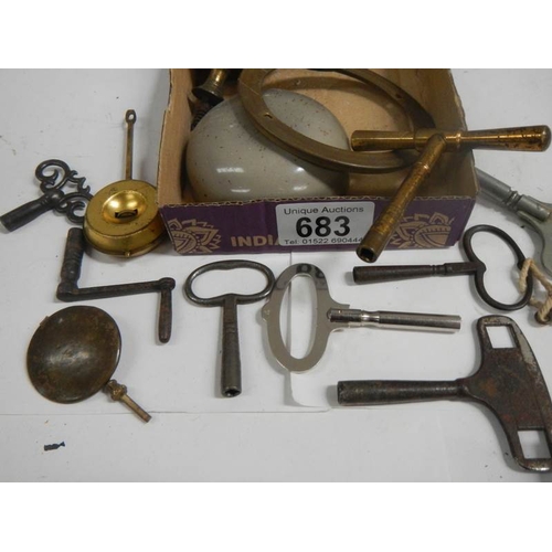 683 - A mixed lot of clock parts including bells, keys etc.,