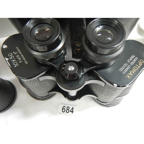 684 - A pair of Super Zenith 12 x 50 binoculars together with  a pair of Optomax 10 x 50 binoculars.