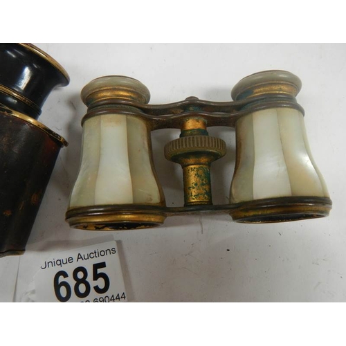 685 - 2 pairs of vintage opera glasses, one mother of pearl and the other brass with leather covering.