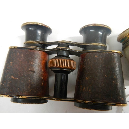 685 - 2 pairs of vintage opera glasses, one mother of pearl and the other brass with leather covering.