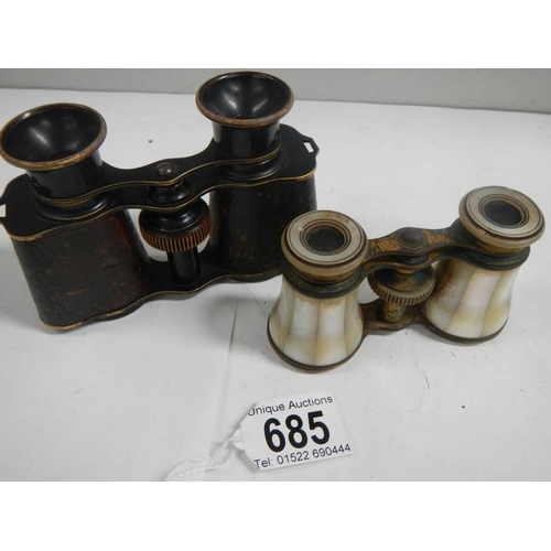 685 - 2 pairs of vintage opera glasses, one mother of pearl and the other brass with leather covering.