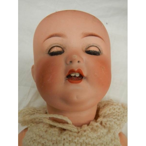 841 - A Victorian porcelain headed doll, missing wig, 19.5''.