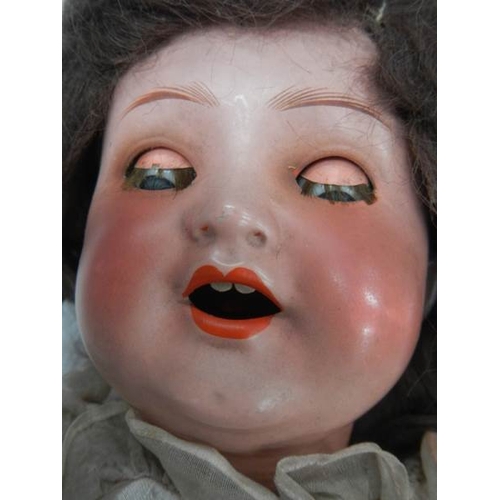 842 - A Victorian porcelain headed doll, missing wig, 17''.