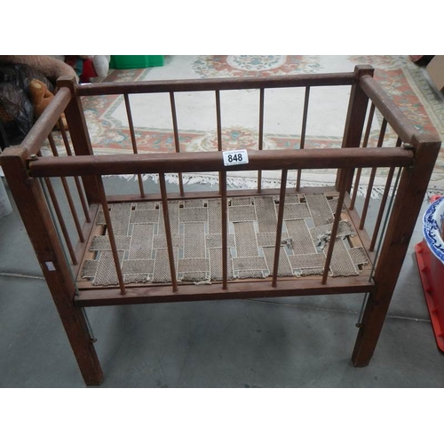 848 - An old dolls cot with drop sides.