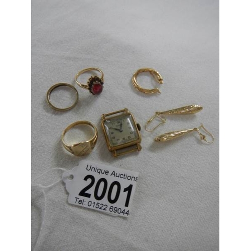 2001 - A mixed lot of gold including rings, watch head etc.,