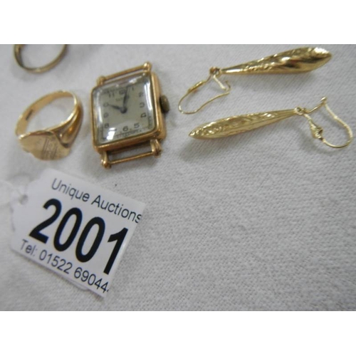 2001 - A mixed lot of gold including rings, watch head etc.,