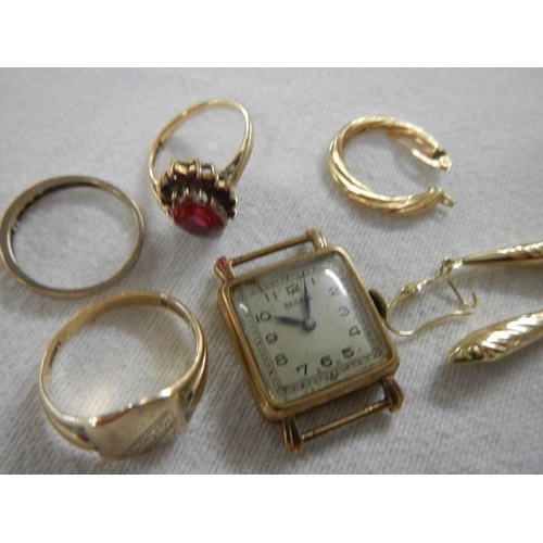 2001 - A mixed lot of gold including rings, watch head etc.,