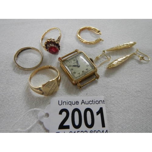 2001 - A mixed lot of gold including rings, watch head etc.,