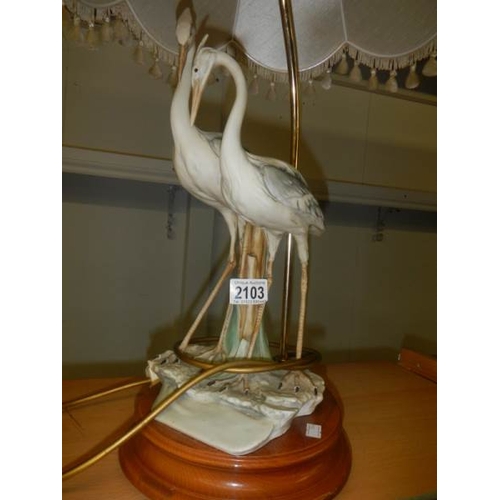 2103 - A good quality mid - late 20th century Capodimonte table lamp being figures of storks, 31'' tall a/f