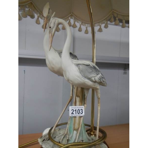 2103 - A good quality mid - late 20th century Capodimonte table lamp being figures of storks, 31'' tall a/f