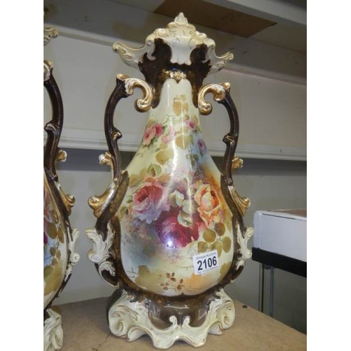 2106 - A pair of Staffordshire vases, some crazing and one handle has repair.