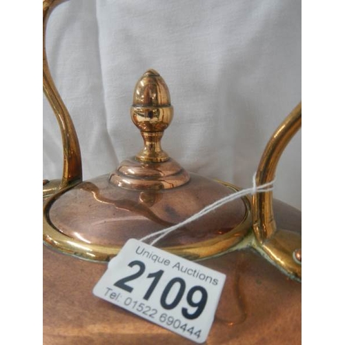 2109 - A Victorian copper kettle with bronze handle.