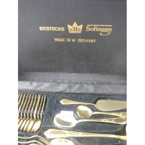 2119 - A gilded 12 place setting cutlery set by Besteoke Solingen, Germany.