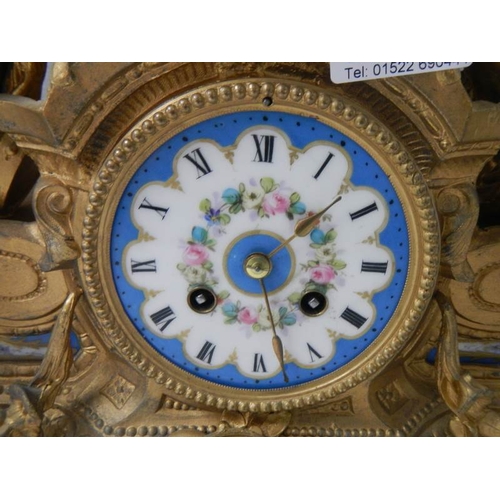 2137 - An ornate French gilt bronzed case mantel clock inset with painted porcelain panels surmounted with ... 