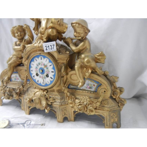 2137 - An ornate French gilt bronzed case mantel clock inset with painted porcelain panels surmounted with ... 