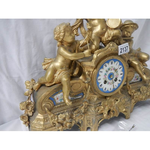 2137 - An ornate French gilt bronzed case mantel clock inset with painted porcelain panels surmounted with ... 