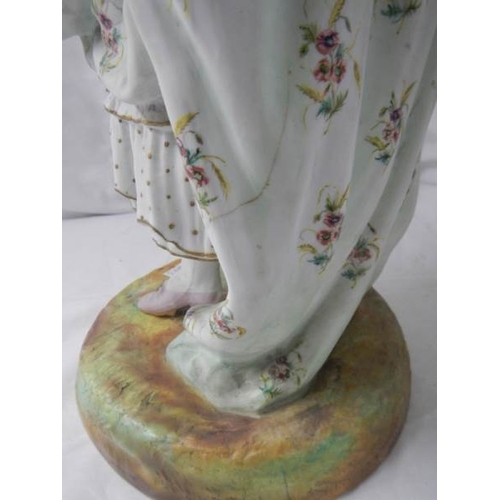 2138 - A tall bisque figure of a lady, 25'' tall, a/f see images.