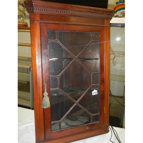 2150 - A mahogany astragal glazed hanging corner cabinet.