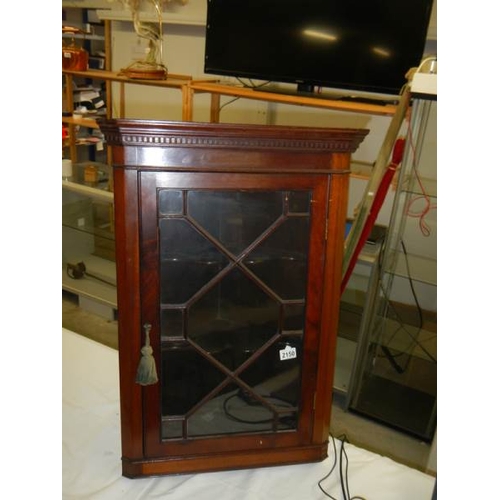 2150 - A mahogany astragal glazed hanging corner cabinet.