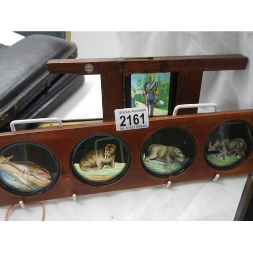 2161 - A collection of coloured glass lantern slides in mahogany frames.