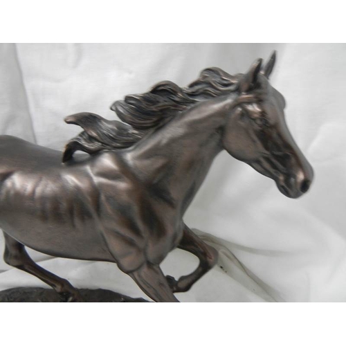 2168 - A bronzed resin horse, 16'' long x 12'' tall.