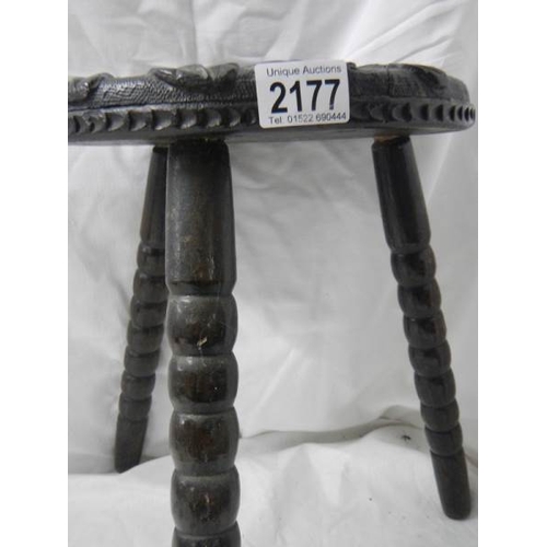 2177 - A carved stool on bobbin style legs.