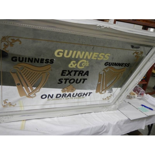 2184 - A large bevel edged mirror with Guinness advertising.