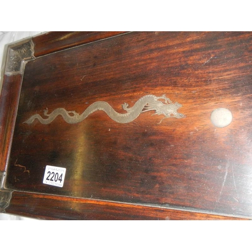 2204 - A Chinese rosewood tray with silver embellishments including dragon in centre.