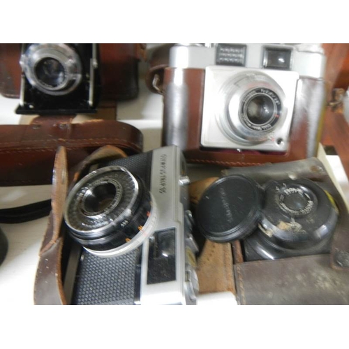 2210 - A pair of binoculars and a quantity of old camera's.