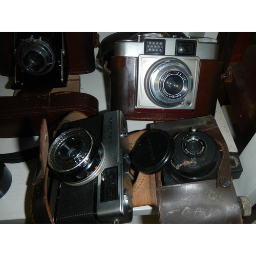 2210 - A pair of binoculars and a quantity of old camera's.