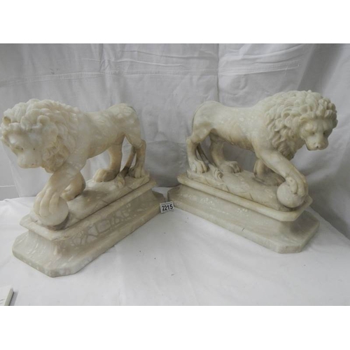 2215 - A matching pair of Victorian alabaster lions on bases.