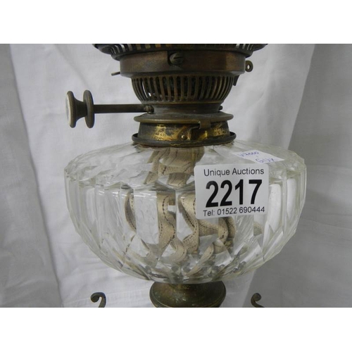 2217 - A Victorian brass oil lamp with cut glass font.