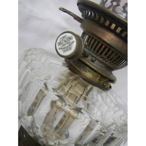 2217 - A Victorian brass oil lamp with cut glass font.