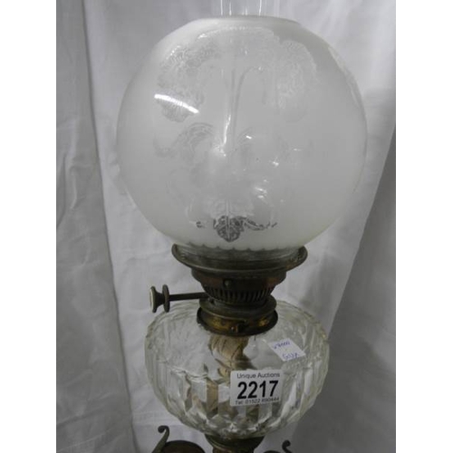 2217 - A Victorian brass oil lamp with cut glass font.