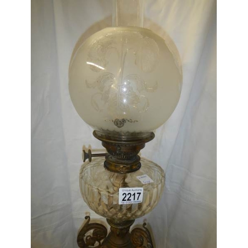 2217 - A Victorian brass oil lamp with cut glass font.