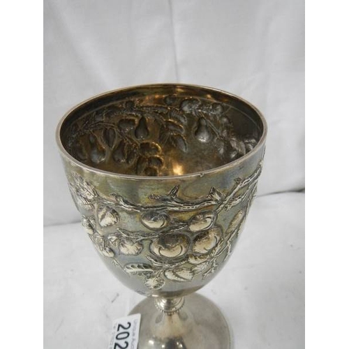 2028 - A good hall marked silver embossed chalice, 240 grams.