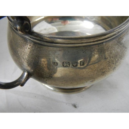 2029 - A 3 piece hall marked silver tea set and sugar nips, 684 grams.