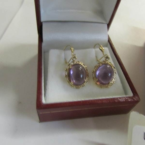 2054 - A pair of amethyst set ear pendants in yellow metal together with an amethyst set bracelet with deep... 