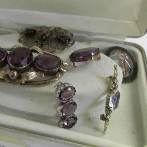 2065 - A collection of late 19th century brooches with amethyst coloured stones together with other vintage... 