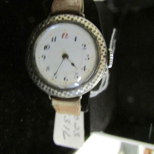 2067 - An early 20th century ladies watch in silver set with Neillo work around dial, in working order.