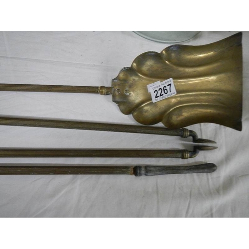 2267 - A set of Victorian reeded brass fire irons, 25'' long.