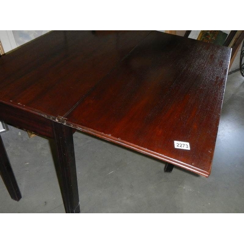 2272 - A fold over card table on square mahogany legs.