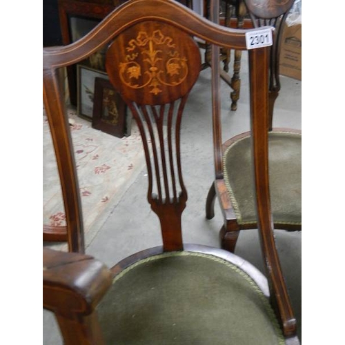 2301 - A set of 4 mahogany inlaid chairs.