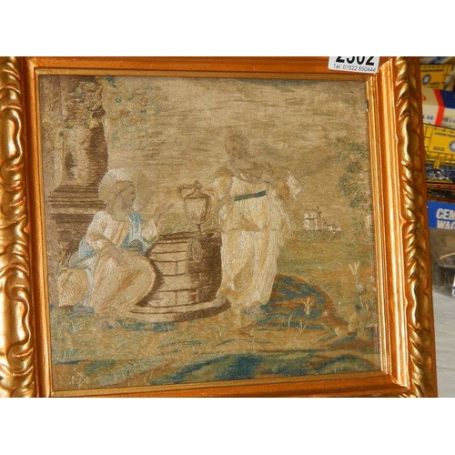 2302 - A gilt framed Italian antique embroidery depicting Jesus Christ at a well with a woman.  Hand writte... 