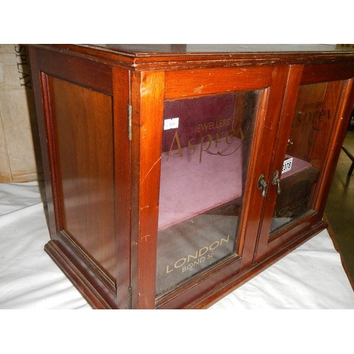 2378 - A mahogany jewellery cabinet signed for Asprey's.