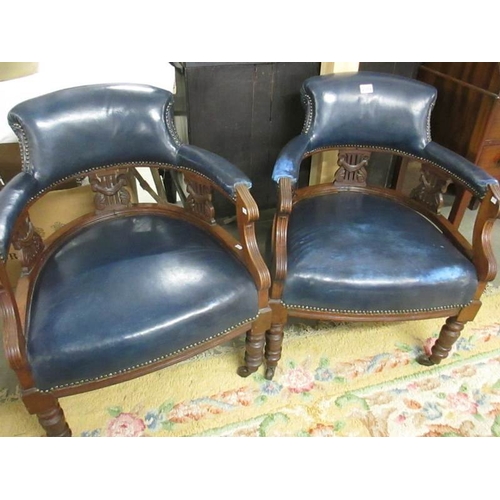 2389 - A pair of blue leather arm chairs.