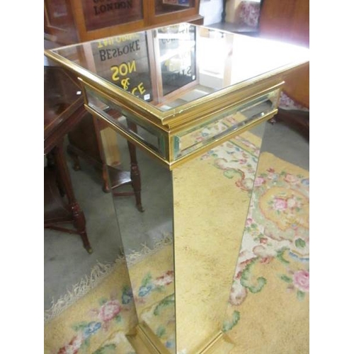 2394 - A pair of bevelled mirrored glass pedestals, 39'' tall.