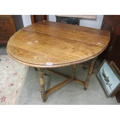 2398 - A mid 20th century oval oak gate leg table.