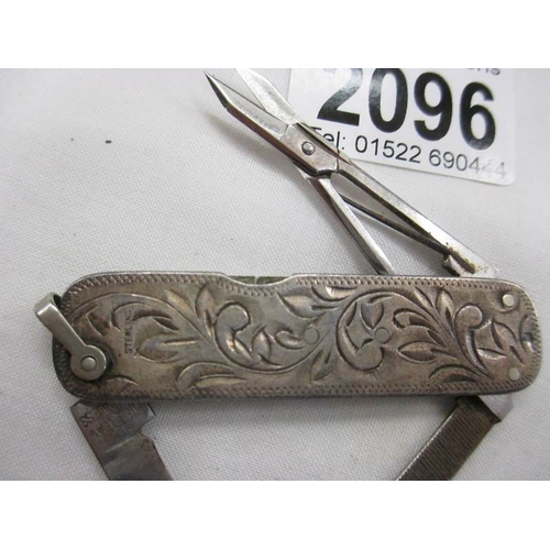 2096 - An engraved stirling silver pocket knife with 2 blades, nail file and scissors.